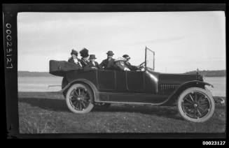 Six people, including Captain Edward Robert Sterling, in a car