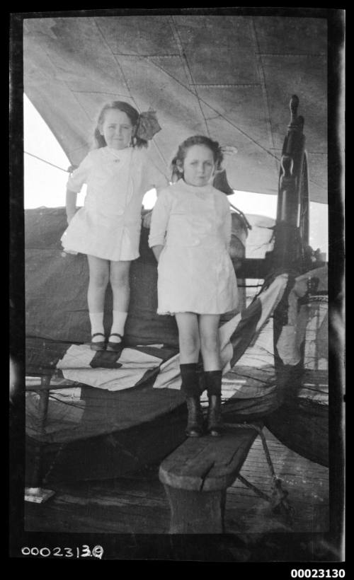 Two little girls, possibly related to Captain Edward R Sterling, standing on a ship's deck