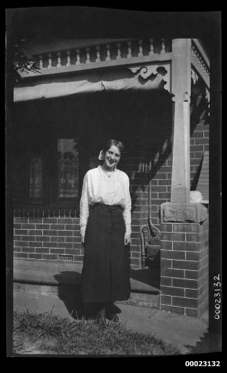 Portrait of a woman, possibly related to Captain Edward R Sterling, in front of a house