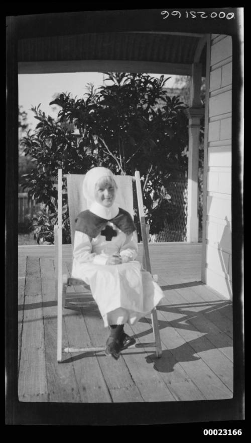 Girl dressed in a medical uniform sitting on a veranda