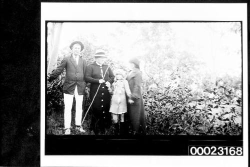 Group portrait in front of trees and shrubbery