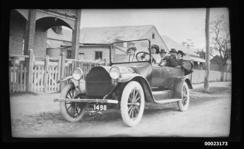 Captain E R Sterling with passengers in an automobile