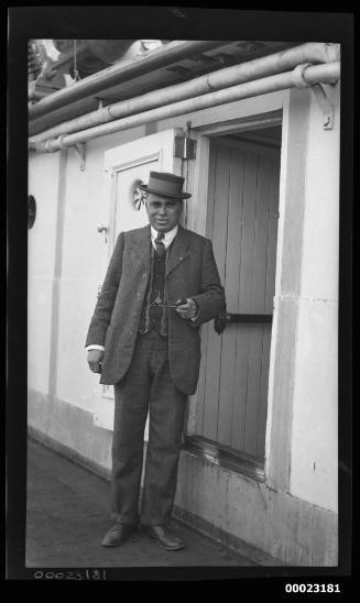 Unidentified man standing in front of an open doorway of a vessel