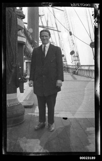 Man in suit on a ships deck