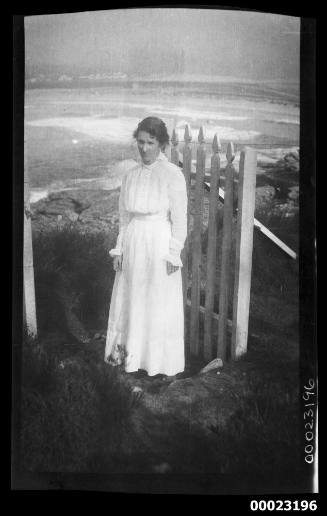 Woman standing in open picket gate