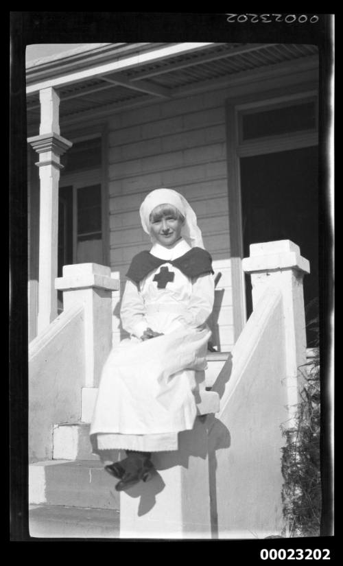 Girl on front steps of a house