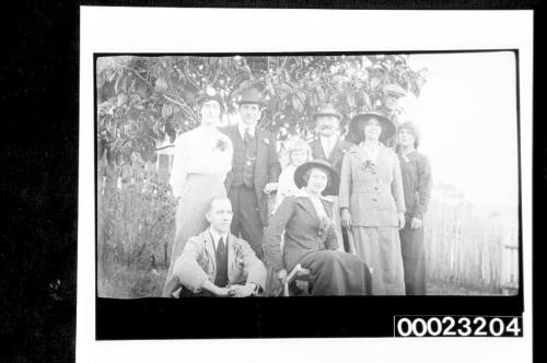 Unidentified people standing under a tree