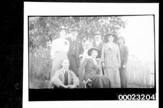 Unidentified people standing under a tree