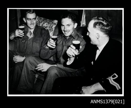 Lieutenant Page, Major Lyons and Lieutenant Davidson enjoy a beer after Operation Jaywick