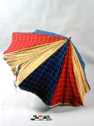 Canvas beach umbrella with blue, yellow and red panels with checks