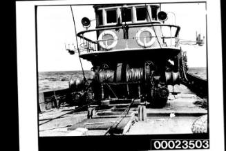 View of winch wound with cable and bridge of a fishing boat