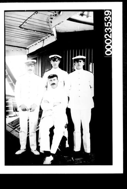 Ships and steamer crews, three uniformed men, one seated