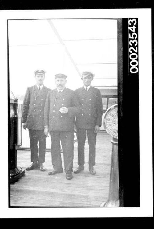 Ships and steamer crews, three officers on bridge of ship