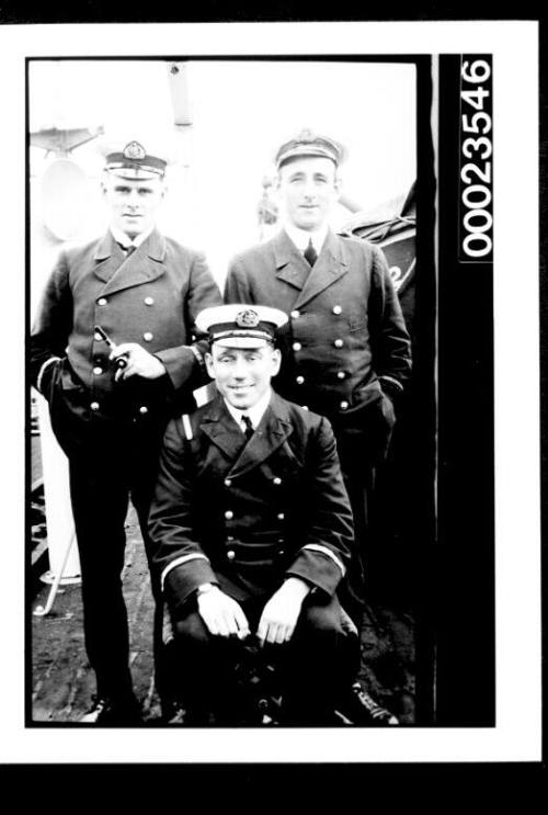 Ships and steamer crews, two men standing behind one seated
