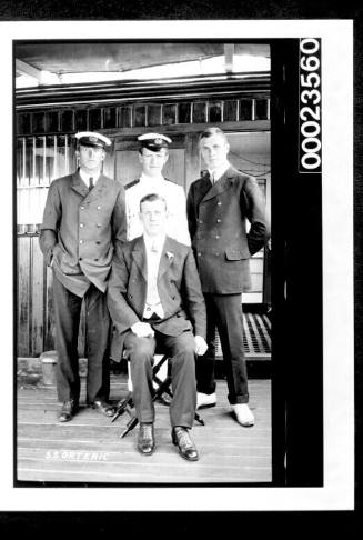 Ships and steamer crews, three men seated