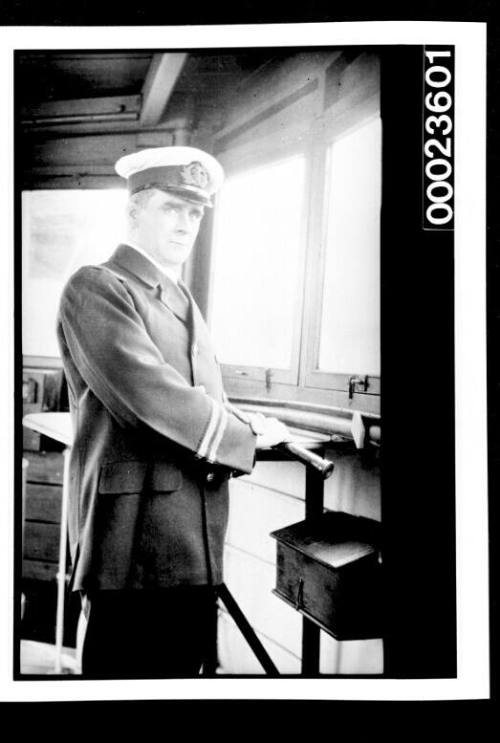 Ships and steamer crews, man in uniform standing with telescope