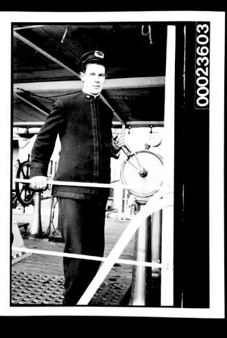 Ships and steamer crews, uniformed man on deck holding telegraph