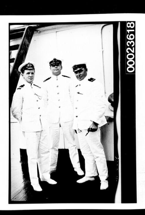 Ships and steamer crews, three men standing on deck