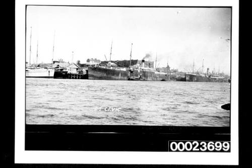 Two four-masted steamships at dock in front of Dalgety's Wool and Grain store