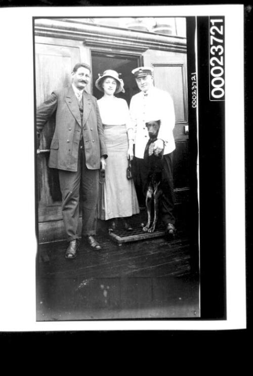 Ship's visitors with officer and a pet dog