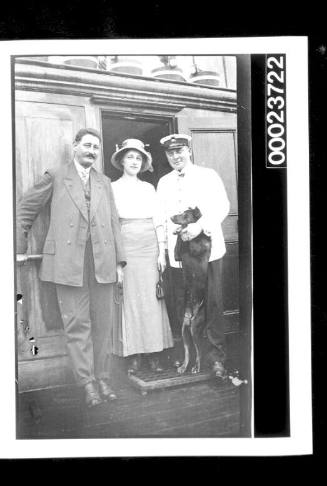 Ship's visitors with an officer and a pet dog