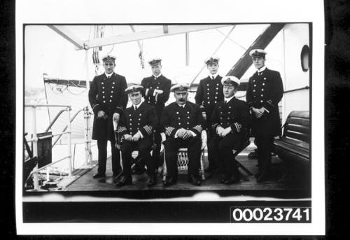 Seven men in naval uniform