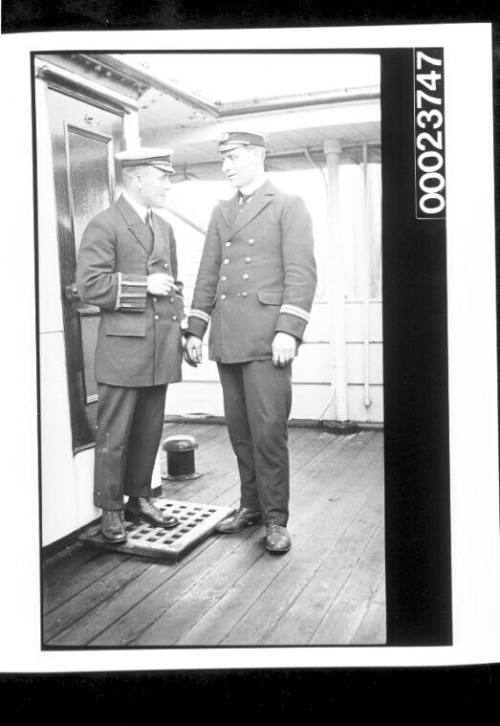 Two men in naval uniform