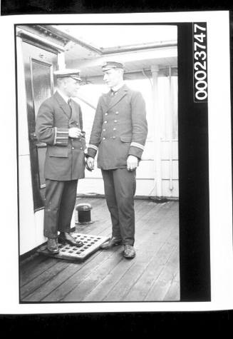 Two men in naval uniform