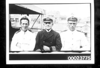 Three officers on ship deck