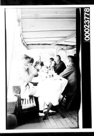 Men seated a long dining table