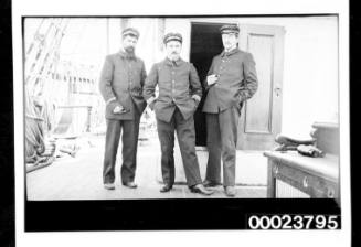 Three men in two piece uniforms