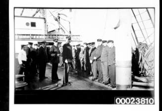 Two groups of officers and crew on deck