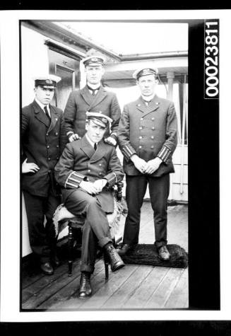 Four officers on ships deck