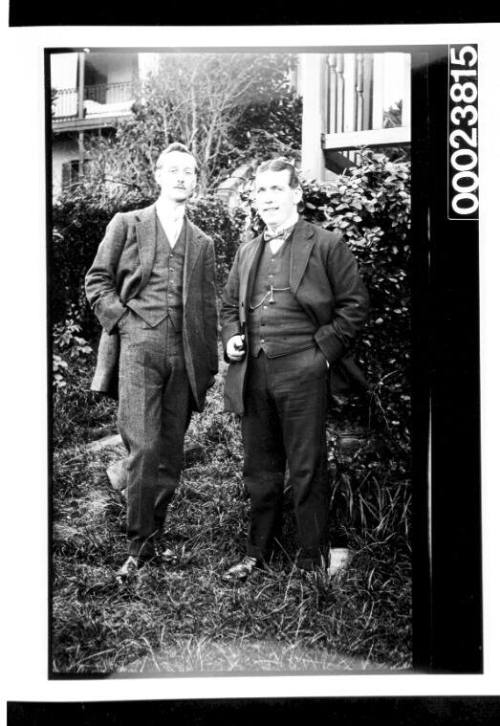 Two men standing in garden setting