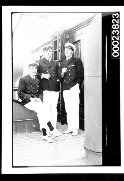 Three officers on ship deck