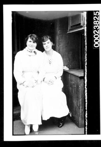 Two women in long white dresses