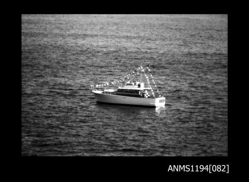 Offshore powerboat racing 1970s, motor cruiser with bunting flags