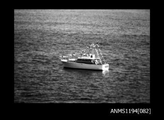 Offshore powerboat racing 1970s, motor cruiser with bunting flags