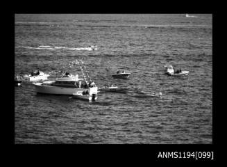 Offshore powerboat racing 1970s, motor cruiser surrounded by powerboats