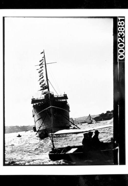 Dressed ship and small boat in foreground