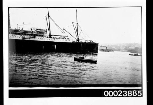 Masted steam ship and a small boat EMPIRE in the foreground