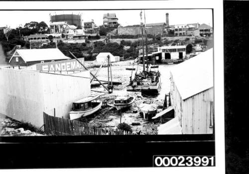 Small inlet with water at centre and boat shed at edge