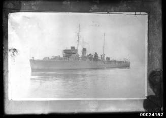 Portside view of a naval sloop in open water