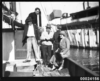 Five people gathered on a ship's deck
