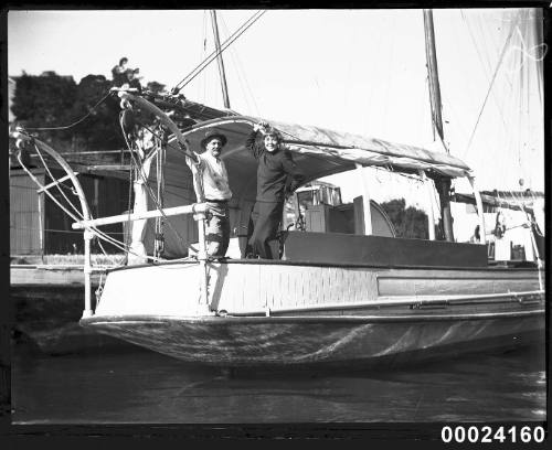 Two people on the deck of a sailing vessel