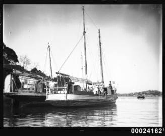 Starboard view of a sailing ship moored to a second sailing vessel at a wharf