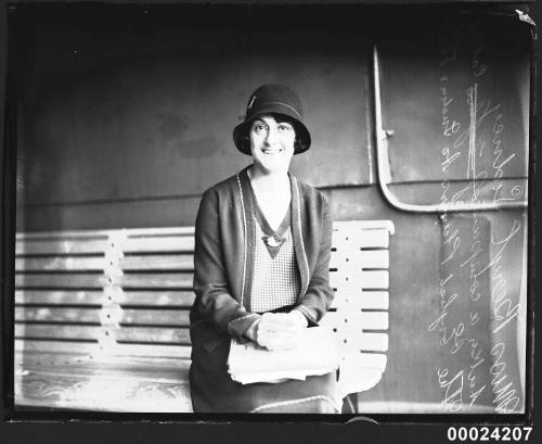 Portrait of theatre actress Beryl Sidney sitting on a bench on board RMS MOLDAVIA II