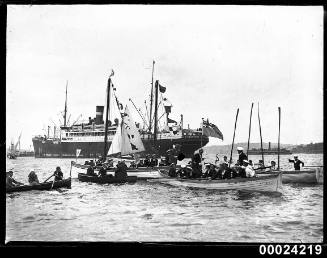 Sailing boats with crew and dinghies on the Harbour