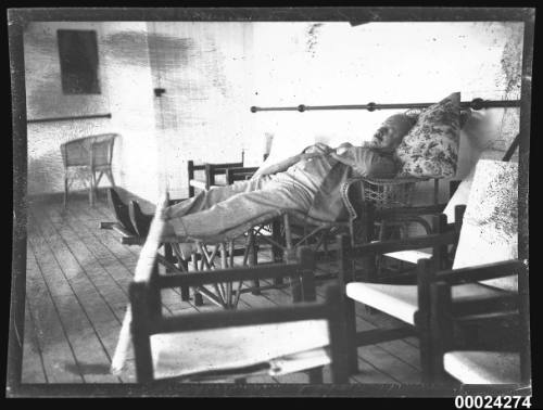 Civilian man lying on a lounge chair possibly on the deck of SS TANDA