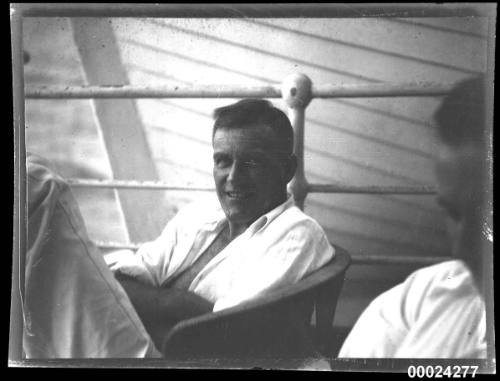 Portrait of a man in a cane deck chair possibly on board SS TANDA